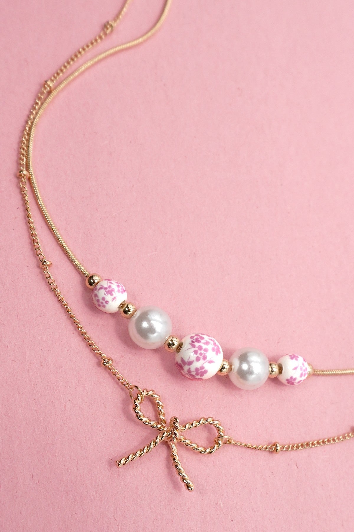 PINK TOILE PATTERN PEARL AND BOW NECKLACE