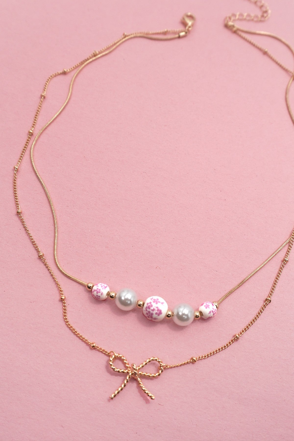 PINK TOILE PATTERN PEARL AND BOW NECKLACE